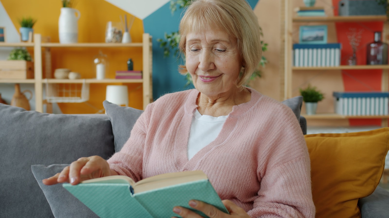Senior woman reading comfortably in a calm living room