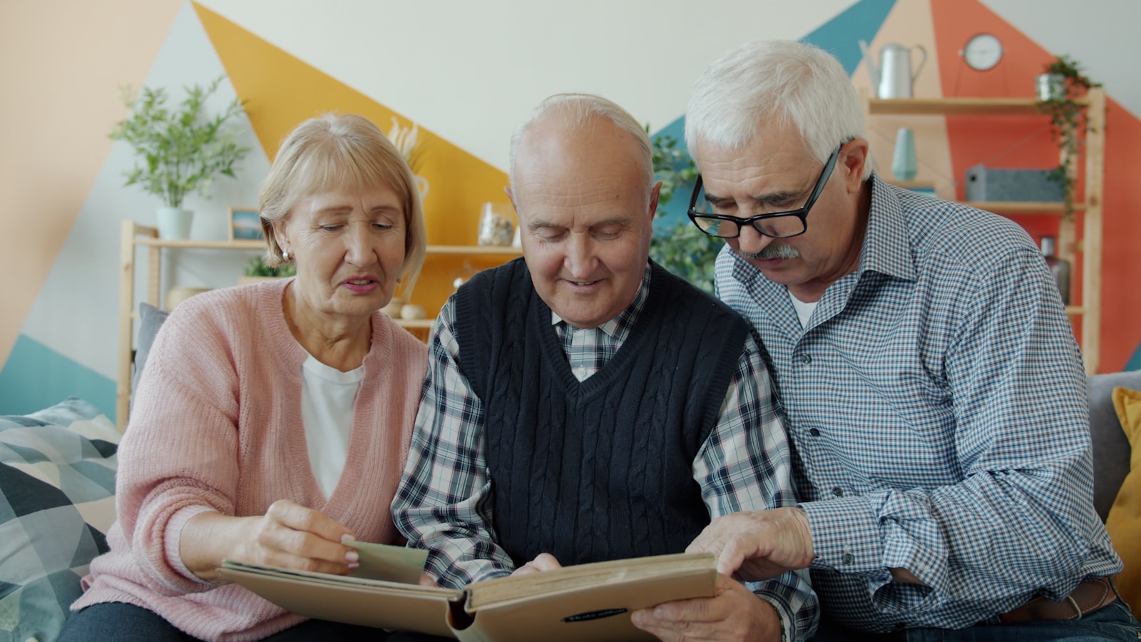 Seniors looking through a photo album together while sorting belongings